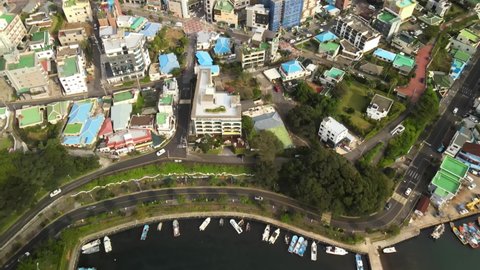 4K Aerial View over a Bustling Town near Seogwipo Port, Jeju Volcanic Island. Jeju Volcanic Island, South Korea, is a UNESCO World Heritage site.