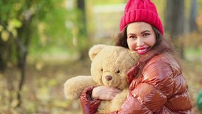 Close up portrait of beautiful woman with brown eyes in knitted red hat. happy smile. close up view. Slow motion video. stock footage