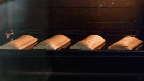 Puff pastry (Friands) with cheese baking in oven time-lapse