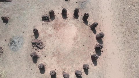 African UNESCO site, 6000 year-old Wassu stone circles seen from above. Gambia. Drone zoom out.