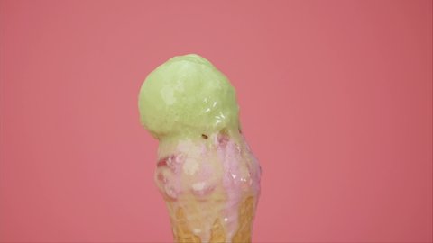 Sherbet ice cream on top strawberry ice cream cone on pink background.