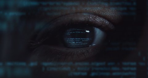 Cinematic macro of young programer's blu eye with latest innovative sophisticated technology display application with augmented reality holograms for realization of new codeproject.
