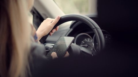 Checking Email Chats And Reading News. Female Writing Message In Vehicle On Social Network Chats On Cellphone. Texting And Driving Car On Social Media. Woman Texting On Smartphone While Driving Car