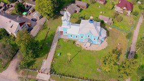 4K aerial - a bird's eye view video (Ultra High Definition). Sunny summer view from flying drone of Svyato-Symeonivsʹka  church, Volyn region, Ukraine, Europe. Traveling concept background.