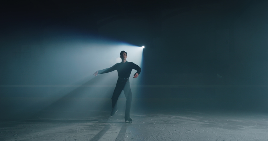 Cinematic shot of young male artistic figure skater is performing a man's single skating choreography on ice rink before start of a competition. Concept of perfection, precision, freedom, passion. | Shutterstock HD Video #1063242853