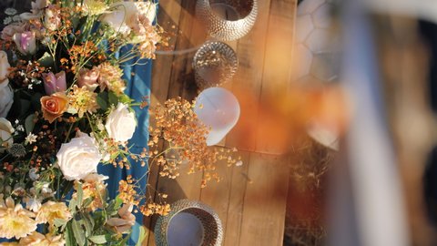 Colourful Floral center piece bouquet on wooden table in retro arrangement - Slide Reveal shot