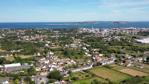 Drone footage over north Guernsey with views over to Herm, Jethou and Sark showing fields, houses, St Sampson , the north east coast and power station.