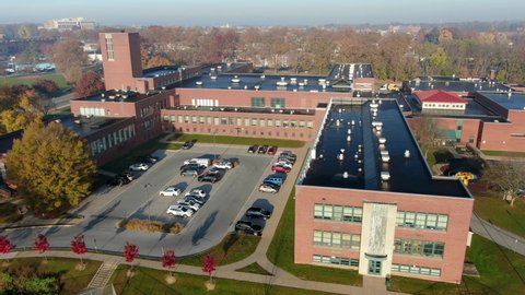 Aerial of large school campus in USA. American education system includes elementary, junior high, middle school, high school secondary levels. United States of America in urban setting.