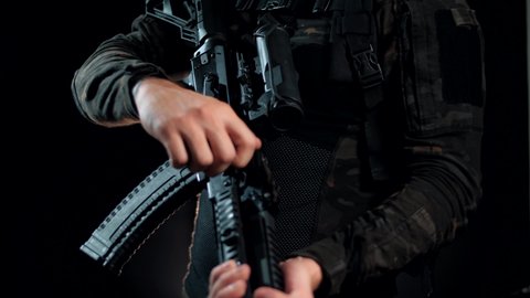 Loading a Kalashnikov assault rifle in a modern tactical body kit