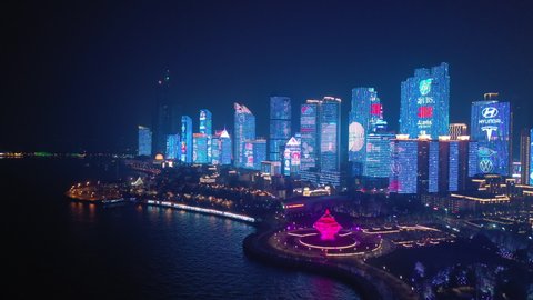 night time illumination show qingdao city downtown famous bay square aerial panorama 4k china