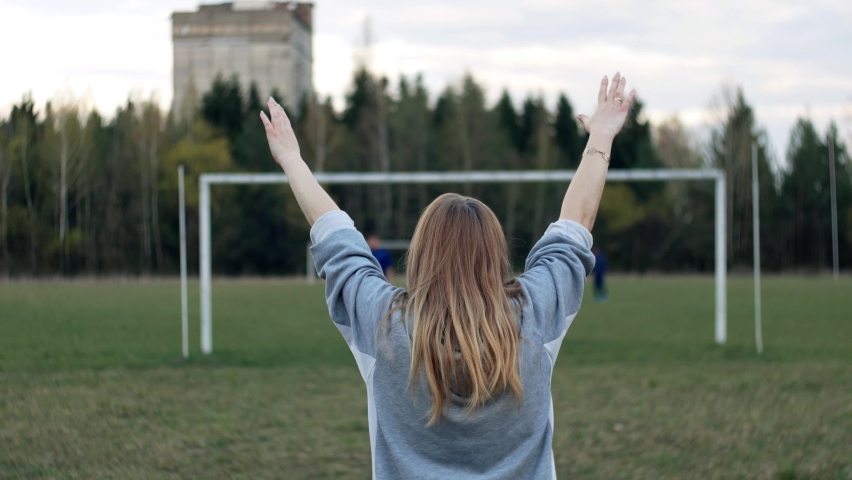 Exercise in the stadium. Woman does physical exercise and performs torso bends