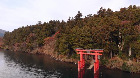 Flying back from the historical Hakone Torii Gate as tourists line up for photos on lake Ashi