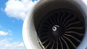 Jet turbine engine of aircraft rotating by wind with cloud and blue sky background.Aviation industry affected by covid-19 pandemic aircraft had to stop all travel flight plan. - Powered by Shutterstock - Get 15% off with code: PIKWIZARD15