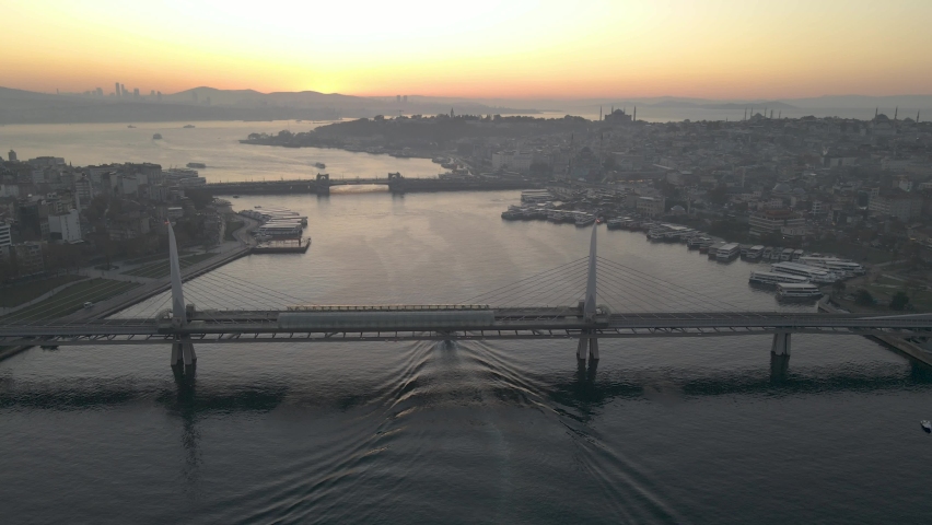 Aerial view of Istanbul Golden horn at Sunrise. Boat crossing under bridge at golden horn of istanbul. | Shutterstock HD Video #1063282720