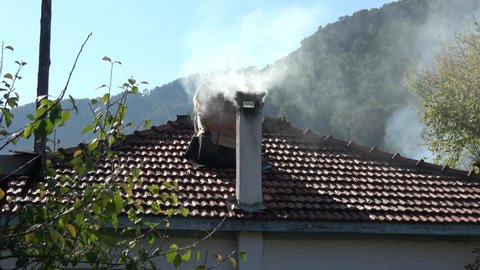 Karacaoren, Mugla, Turkey - 8th of November 2020: 4K House roof and smoking chimney
