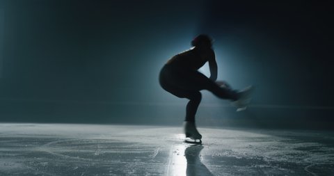 Cinematic shot of young female artistic figure skater is performing a woman's single skating choreography on ice rink before start of a competition. Concept of perfection, precision, freedom, passion.