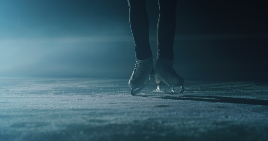 Cinematic close up shot of female figure skater's skating shoes while performing a woman's single choreography on ice rink during a competition. Concept of perfection, precision, freedom, passion. | Shutterstock HD Video #1063295923