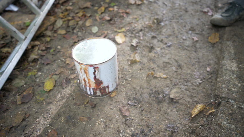 Smashing paint bucket with mattock