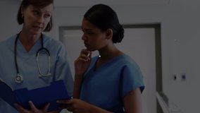 Animation of glowing network of connections against female doctor and female medical professional discussing over file reports at hospital. medicine research science and global networking concept - Powered by Shutterstock - Get 15% off with code: PIKWIZARD15