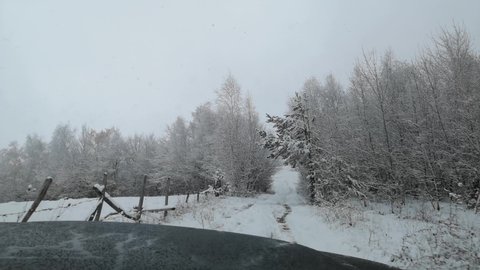 An SUV travels through the winter Carpathians	