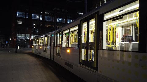 MANCHESTER, UK - 2020: A MediaCityUK tram on the streets of Manchester city at night