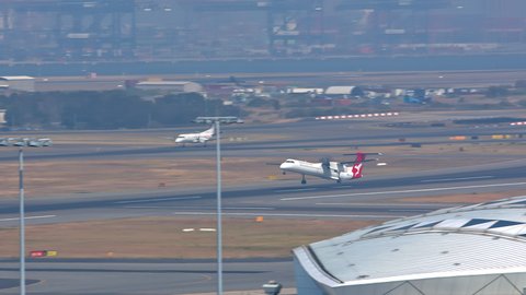 SYDNEY, AUSTRALIA - 2020: QantasLink Dash 8 Q400 Turbo Propeller Regional Airliner Taking Off from Sydney SYD Kingsford Smith International Airport on a Sunny Day in New South Wales Australia