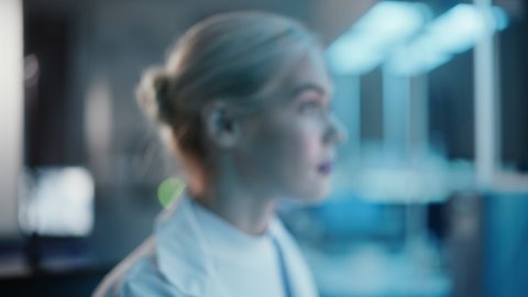 Medical Research Laboratory: Portrait of Beautiful Female Scientist Turning and Looking at Camera Intesely. Advanced Scientific Lab for Medicine, Biotechnology, Vaccine Development. Dark Close-up
