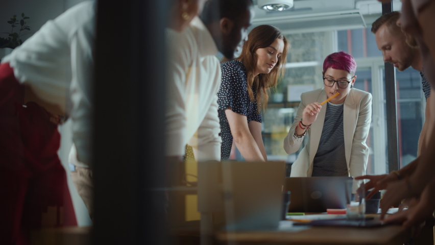 Diverse Team of Professional Businesspeople Meeting in the Office Conference Room. Creative Team Around Table, Specialist with Short Pink Hair Speak for Marketing Compain, Social Media Strategy - Powered by Shutterstock - Get 15% off with code: PIKWIZARD15