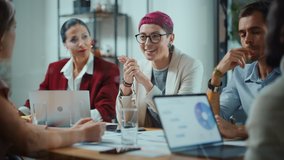 Office Meeting in Conference Room: Beautiful Specialist with Short Pink Hair Talks about Firm Strategy with Diverse Team of Professional Businesspeople. Creative Start-up Team Discusses Big Project - Powered by Shutterstock - Get 15% off with code: PIKWIZARD15