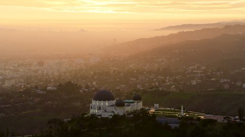 Los Angeles, California, circa 2019: Amazing view of the Griffith Observatory in Mount Hollywood. Los Angeles, California. Beautiful sky during sunset. Shot on RED in 8K.