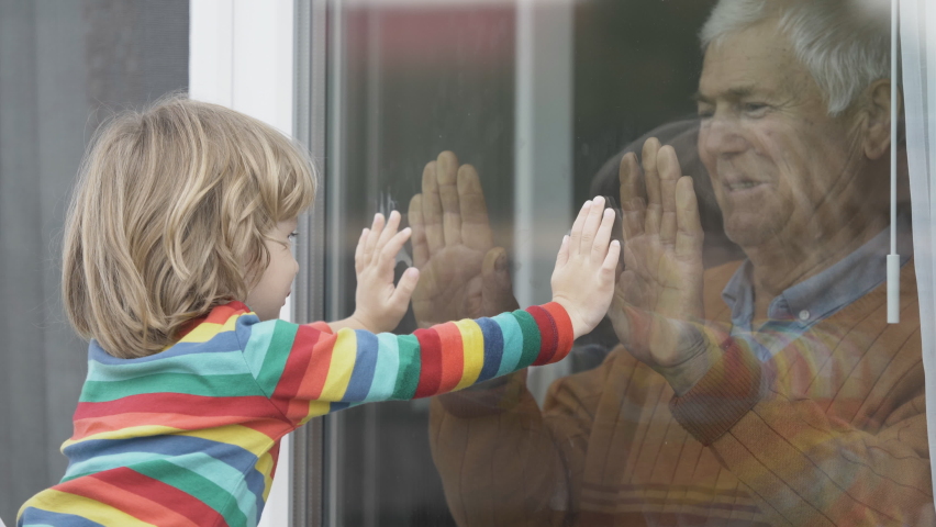 Old man indoor play with child outdoor, touch hand through window, waving hands, kiss, sad quarantine isolation, prison, lock down, free love Royalty-Free Stock Footage #1063315975