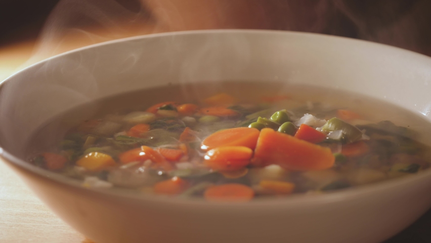 Pour a ladle of minestrone soup. Vegetarian soup dish is on table. Vegetarian healthy meal for dinner. Ready vegetable meal for lunch, hot and cozy soup for dinner at home. Soup with potatoes, carrots Royalty-Free Stock Footage #1063317814