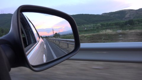 Driving by Rearview Mirror at Sunset, Road Traffic, Pov Tracking Car on Highway, Auto Window View