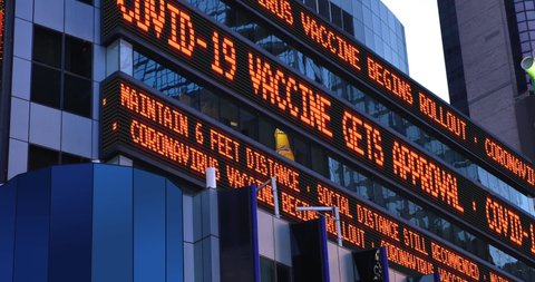 NEW YORK - A Times Square stock market news ticker reports that a COVID-19 Coronavirus vaccine was approved and rollout has begun.	