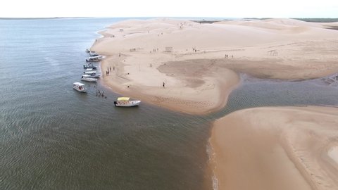 Parnaíba, Piauí, Brazil - 11 10 2020: Aerial view of touristic boats anchored in the border of dunes at Delta do Parnaíba