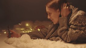 Video of young girl talking with video call among Christmas lights