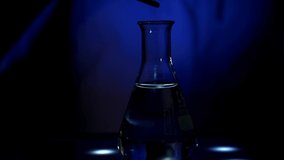 Light-induced reaction performed by a European woman scientist in a biotechnology laboratory under UV light in 4K video for pharmaceutical purpose