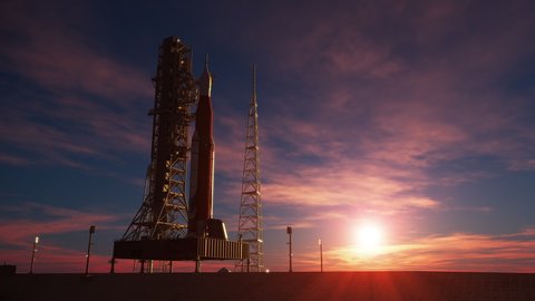 Big heavy rocket (Space Launch System) on the background of the rising sun. 3D animation. 4K. Ultra high definition. 3840x2160.