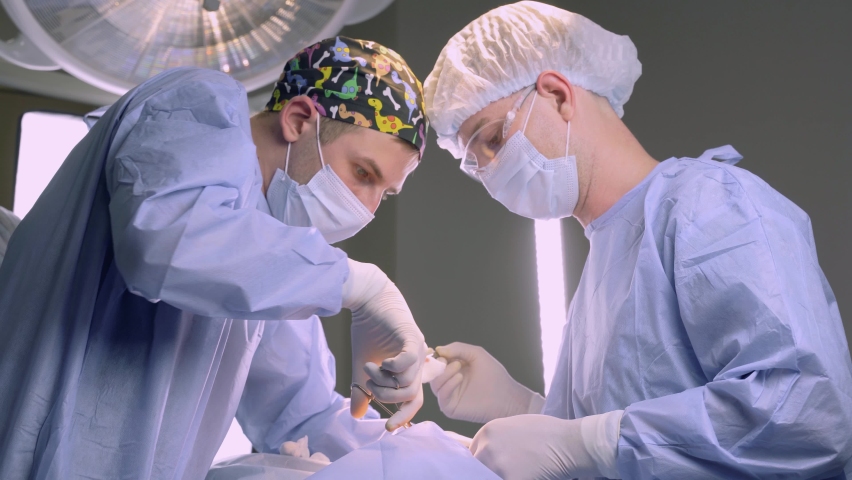 Surgeons do plastic operation in medical clinic. Surgery. Professional medecine. Skin care. Correcting form of face for patient