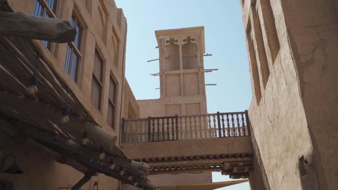 Wind Tower On Traditional Buildings In Historical Neighborhood Of Al Fahidi, Dubai UAE - Handheld, Low Angle