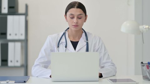 Female Doctor Working on Laptop 