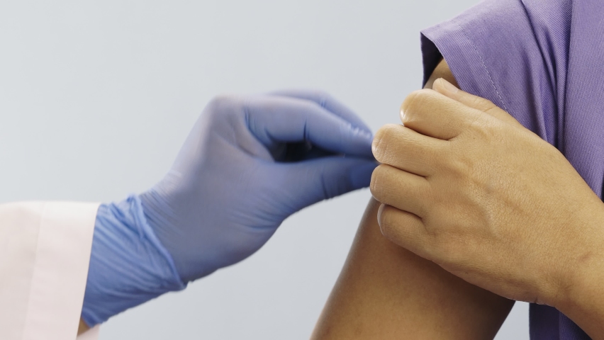 Doctor doing vaccine injection to Medical personnel in hospital.