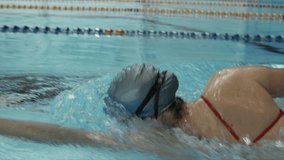 Young professional swimmer training front crawl technique for swimming competition and do flip turn. Slow motion video. - Powered by Shutterstock - Get 15% off with code: PIKWIZARD15