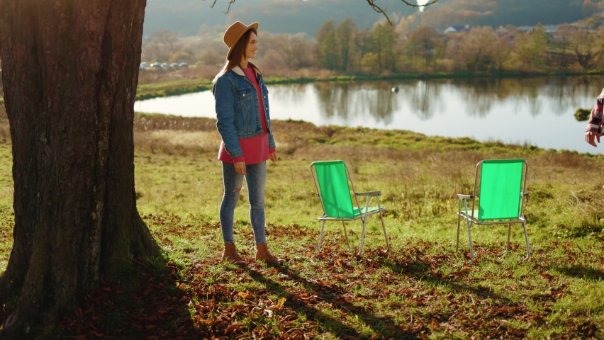 Happy moment in autumn forest near lake man and woman met each other hug stand with dog at sunlight. Animal relaxed portrait cheerful. Close up. Slow motion