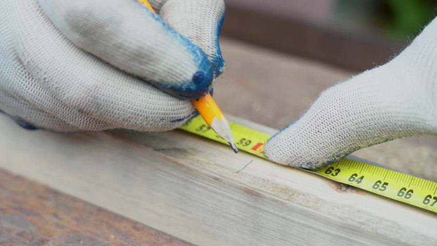 Measure the length of the tape measure. Make a mark with a pencil. Measuring tape measure small Board of wood Royalty-Free Stock Footage #1063354729