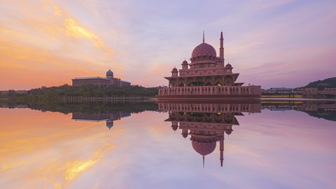 Beautiful Cloudy sunrise Time Lapse at a masjid by a lake in Malaysia at dawn. Zoom in motion timelapse. Prores 4KUHD