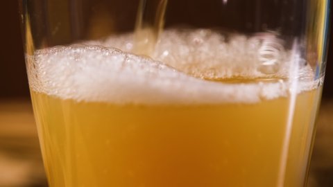 Close up of Unfiltered Beer or Ale Being Poured into a Glass. Food and Drinks, Leisure Lifestyle and Holidays Concept