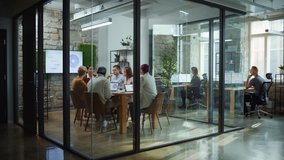 Diverse Group of Professional Businesspeople Meeting in the Modern Office Conference Room. Creative Team Discuss App Design, Analyze Data, Plan Marketing Strategy, Disrupt Social Media, Growth Hack - Powered by Shutterstock - Get 15% off with code: PIKWIZARD15