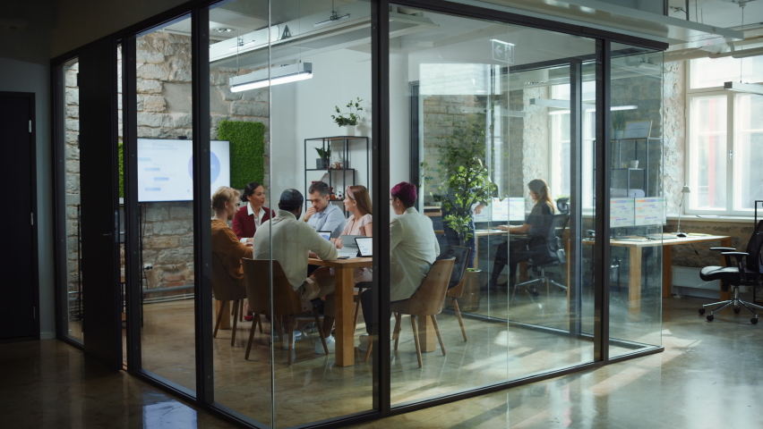 Diverse Group of Professional Businesspeople Meeting in the Modern Office Conference Room. Creative Team Discuss App Design, Analyze Data, Plan Marketing Strategy, Disrupt Social Media, Growth Hack Royalty-Free Stock Footage #1063359214