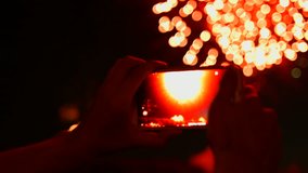 Man records video Fireworks on smart phone